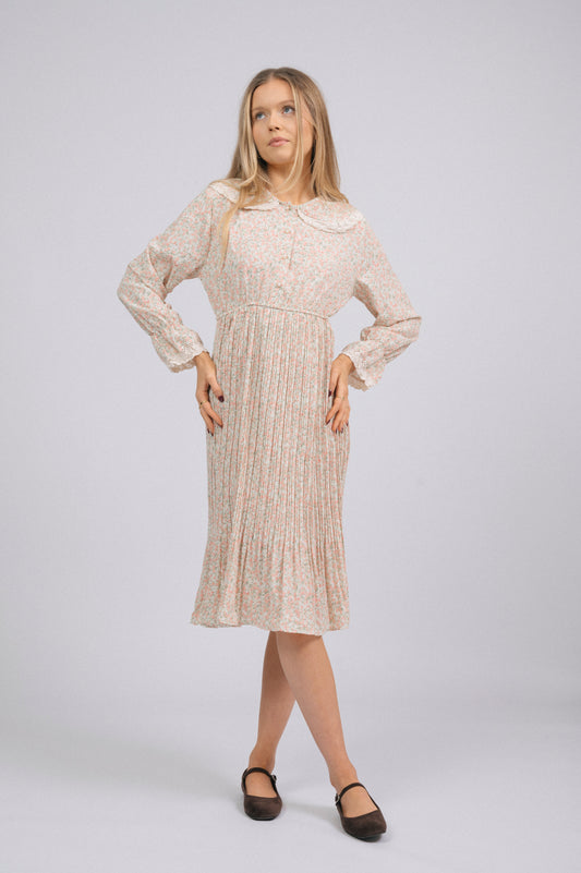 Vintage light pink 1940s-style floral long sleeved midi dress with lace trim, peter pan collar, bell sleeves, and front buttons cottage core prairie style front view - Lemon Lane Vintage