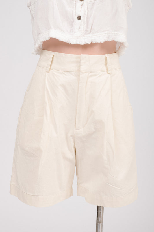 Close-up of lapped fly with hook-and-bar closure and metal zipper on buttercream shorts.