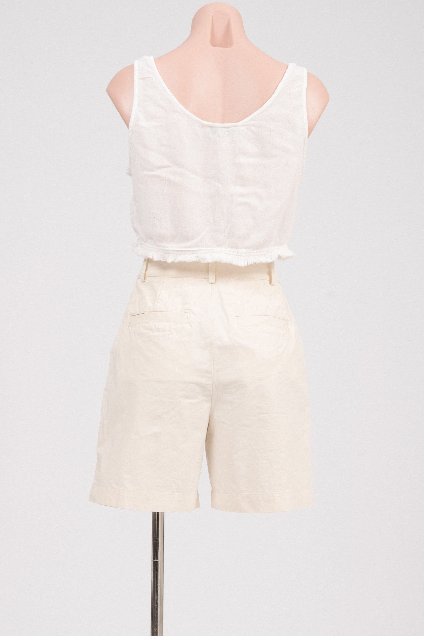 Back view showing pockets on buttercream tailored shorts.