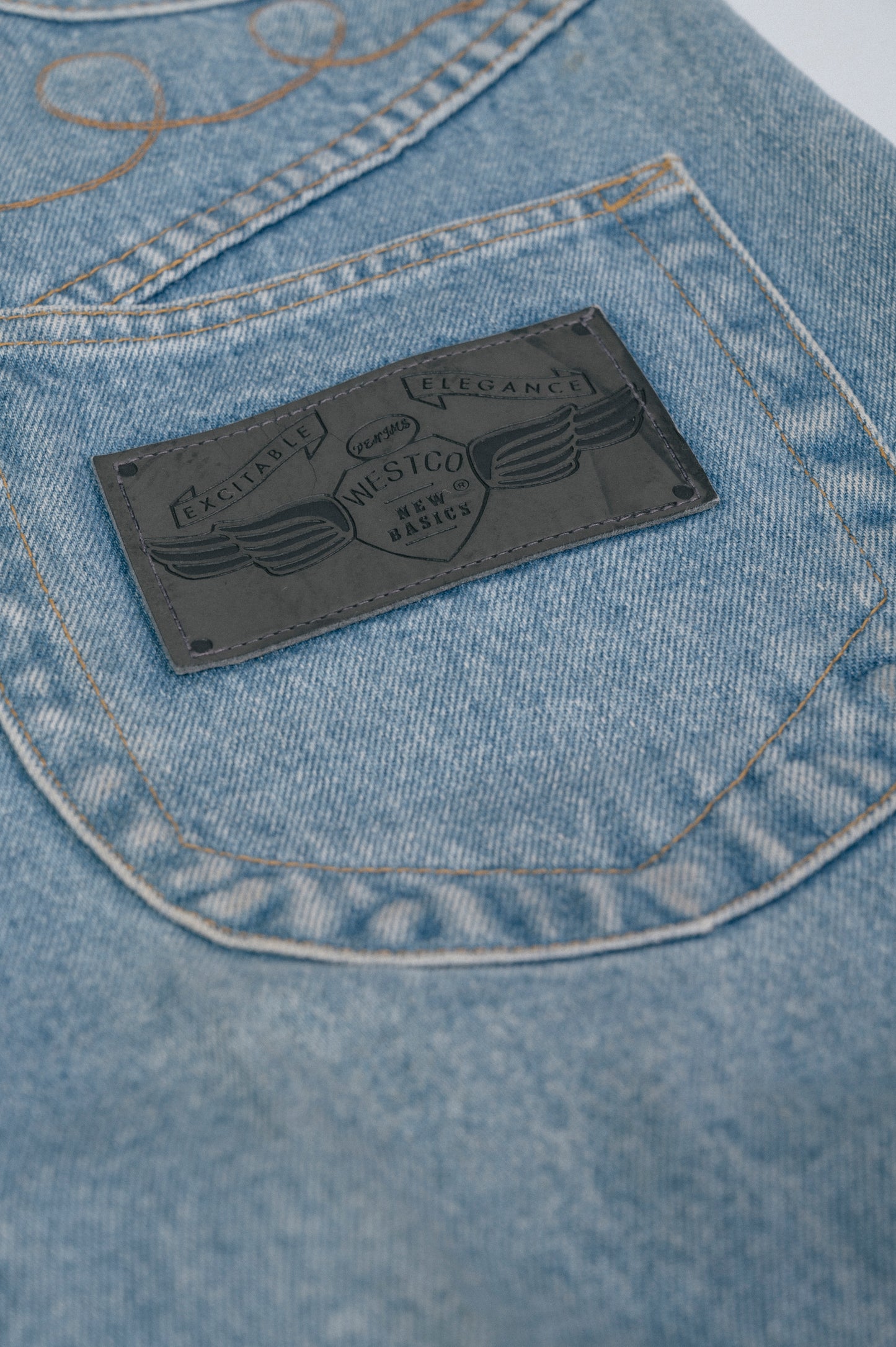 Vintage light denim wash straight leg jeans embroidered detail, denim texture, and pockets close-up - Lemon Lane Vintage