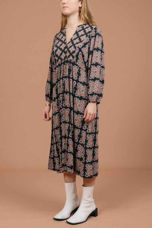 Vintage long sleeved black and multi-coloured maxi dress with geometric pattern side view - Lemon Lane Vintage