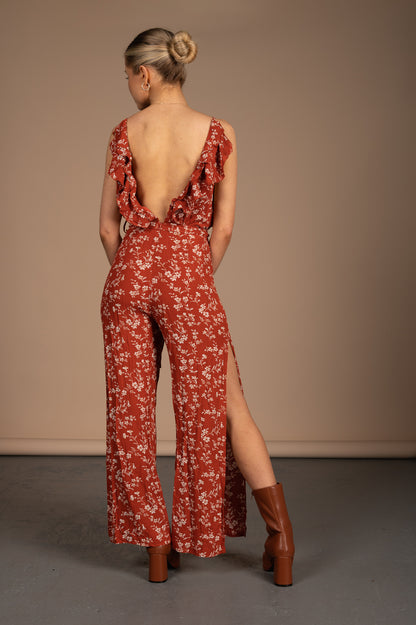 Vintage orange floral jumpsuit with spaghetti straps, ruffle collar, and low back detail back view - Lemon Lane Vintage