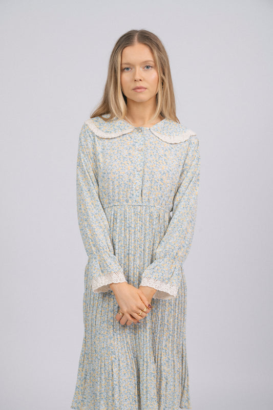 Vintage light blue 1940s-style floral long sleeved midi dress with lace trim, peter pan collar, bell sleeves, and front buttons cottage core prairie style front view - Lemon Lane Vintage