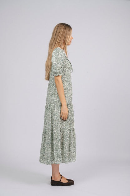 Vintage cottage core green floral tiered midi dress with lace trim, soft peter pan collar, and mid-length puff sleeves side view - Lemon Lane Vintage
