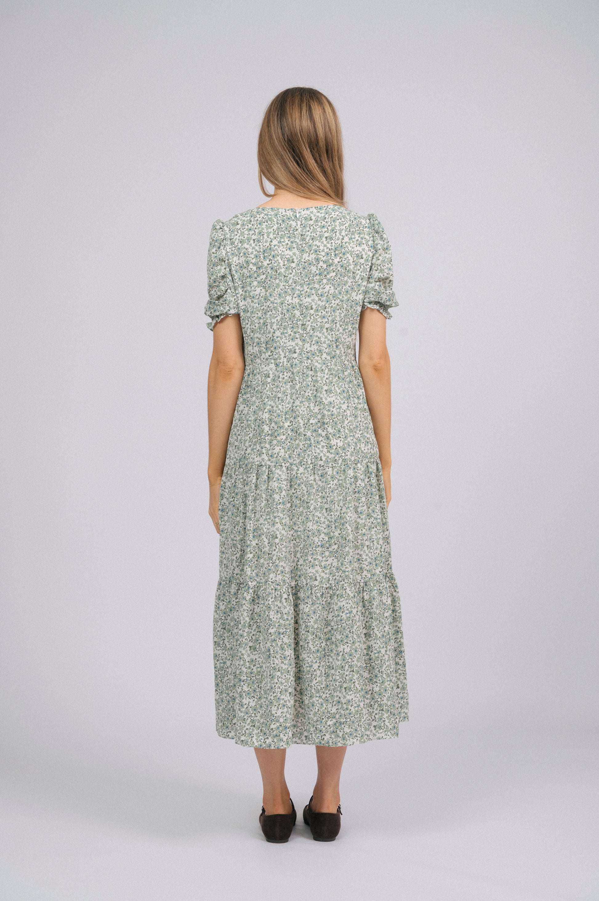 Vintage cottage core green floral tiered midi dress with lace trim, soft peter pan collar, and mid-length puff sleeves back view - Lemon Lane Vintage