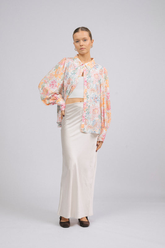 Vintage white floral long sleeved button-up collared shirt with puffy sleeves front view - Lemon Lane Vintage