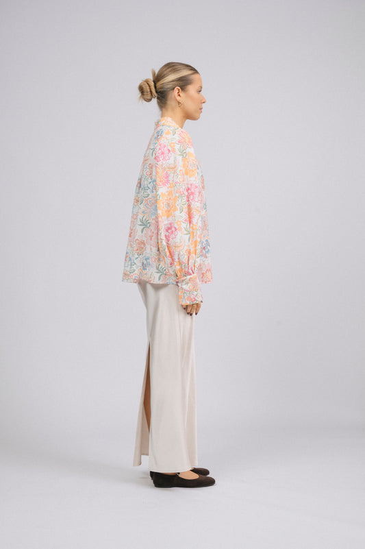 Vintage white floral long sleeved button-up collared shirt with puffy sleeves side view - Lemon Lane Vintage