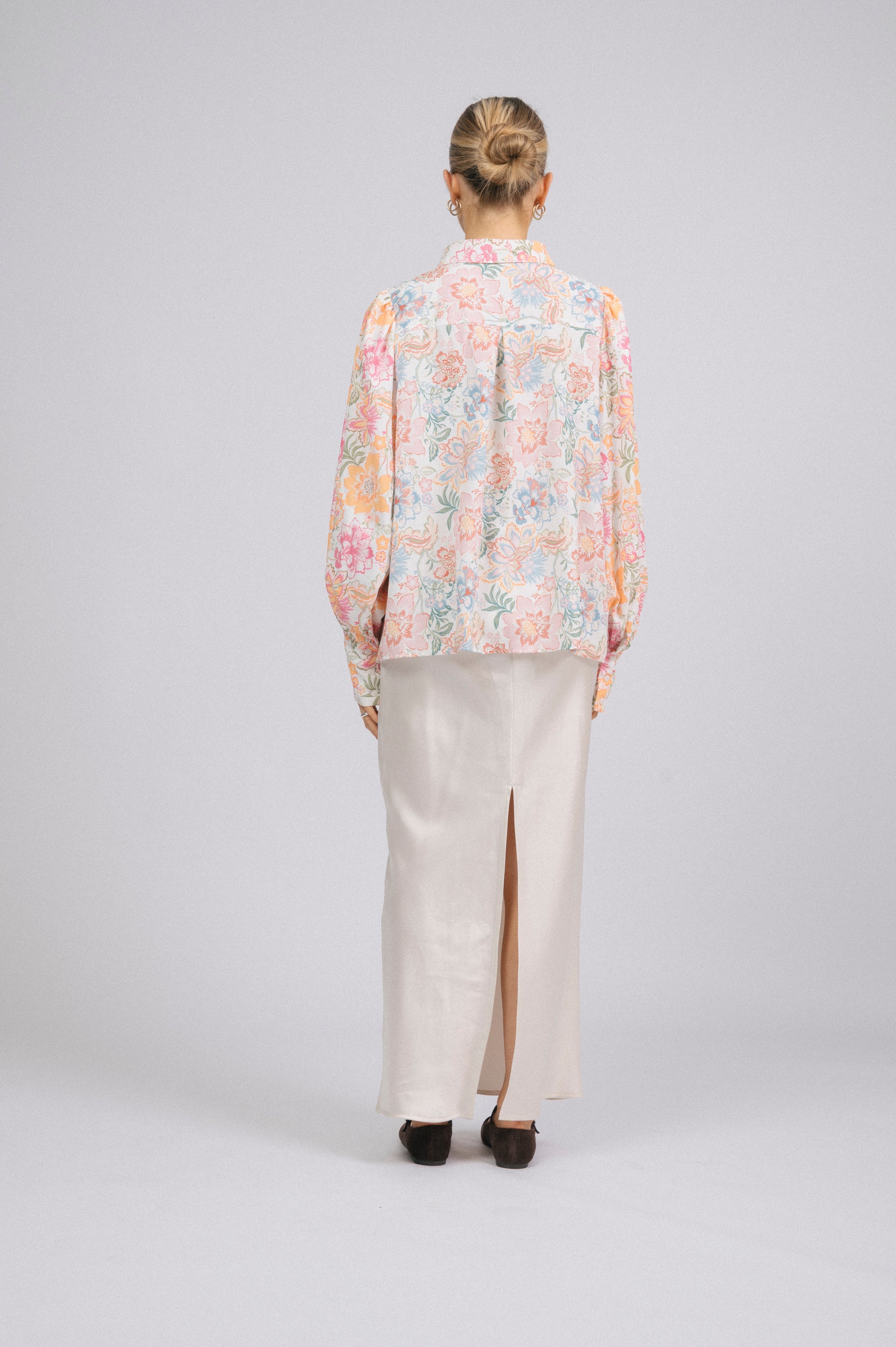 Vintage white floral long sleeved button-up collared shirt with puffy sleeves back view - Lemon Lane Vintage