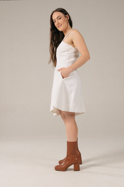 Vintage white A-line bustier mini dress with pockets side view - Lemon Lane Vintage