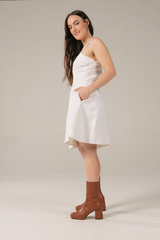 Vintage white A-line bustier mini dress with pockets side view - Lemon Lane Vintage