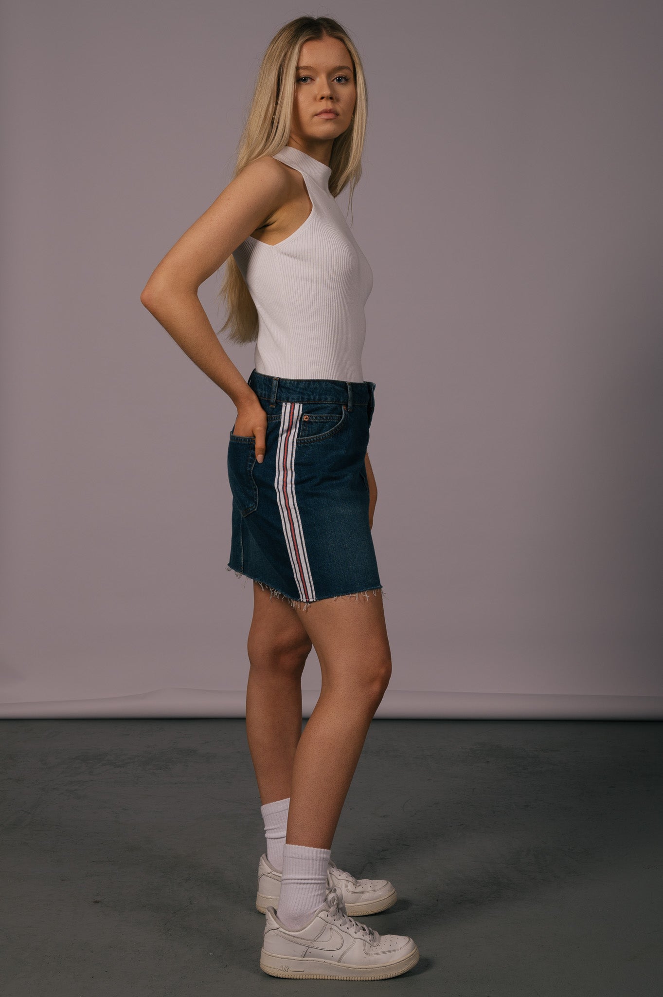 Vintage denim mini skirt with frayed edges  side view - Lemon Lane Vintage