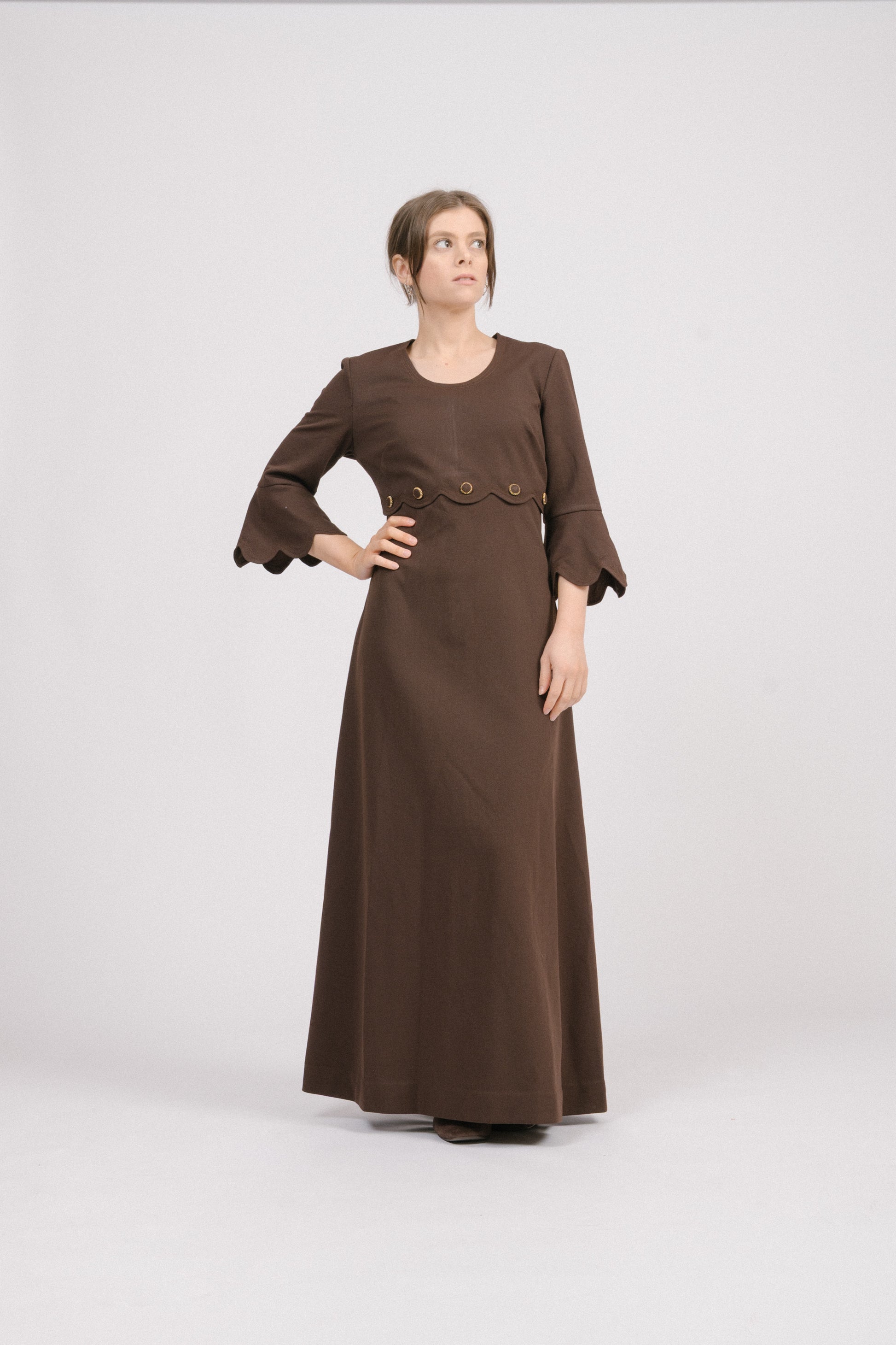 Vintage 1970s brown fit-and-flare maxi dress with scallop trim sleeves.