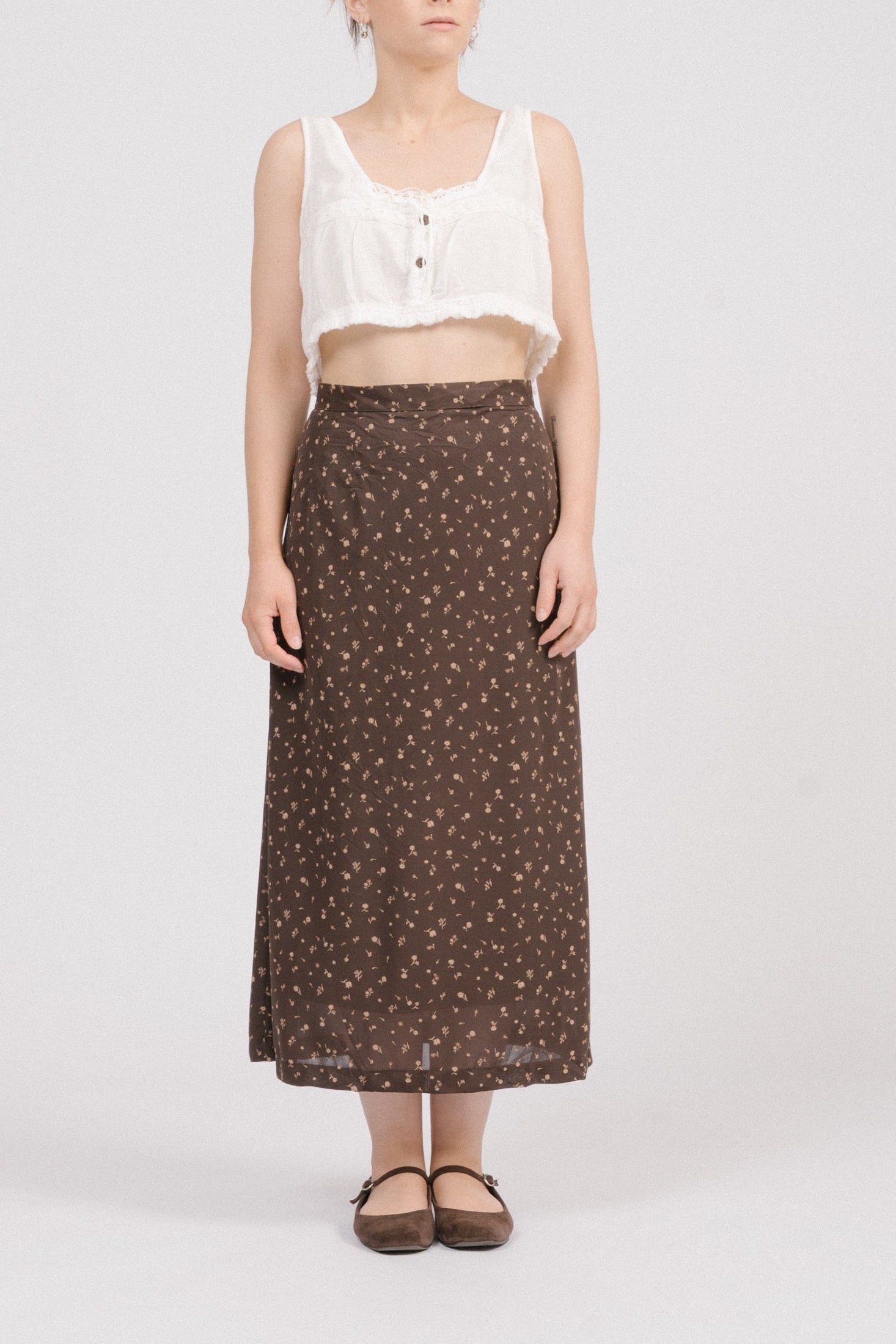 Front view of vintage brown floral midi skirt with beige and light brown florals, straight silhouette, and satin lining. Timeless heirloom-style vintage clothing Australia.