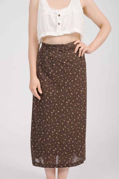 Close-up of fabric and waistband of vintage brown floral midi skirt, showing floral pattern. Timeless, feminine vintage clothing piece.