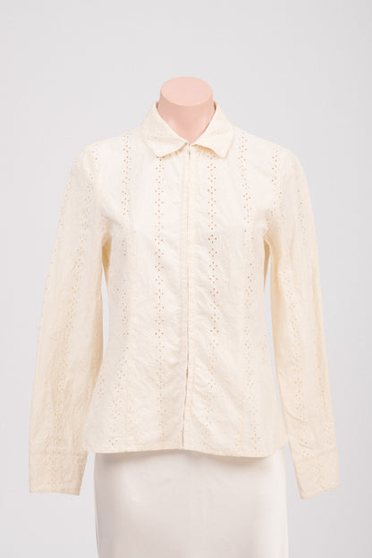Close-up of floral embroidery and cut-out detailing on vintage cream blouse, highlighting delicate design and structured fabric. Timeless feminine vintage clothing Australia.