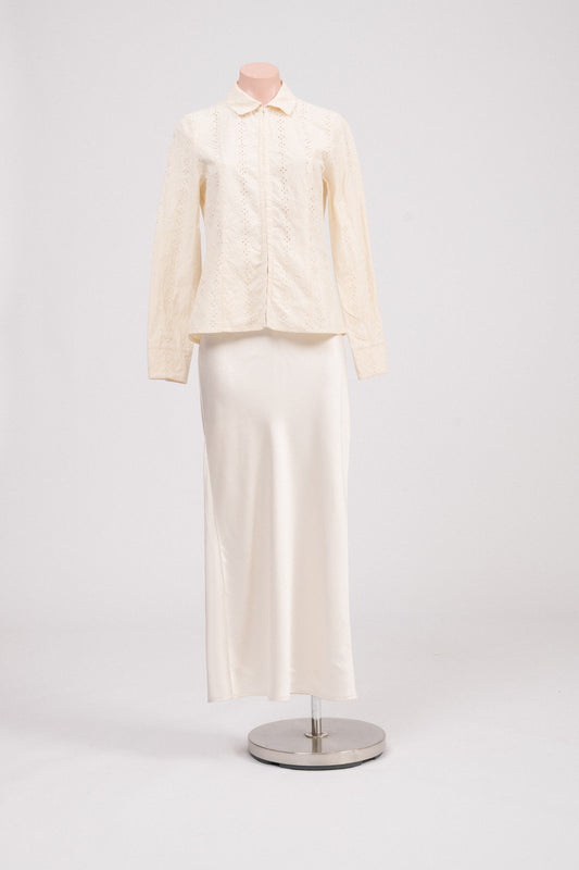Front view of vintage cream floral embroidered blouse with long sleeves, hook-and-eye closure, collared neckline, and delicate cut-out floral detailing. Timeless heirloom-style vintage clothing Australia.