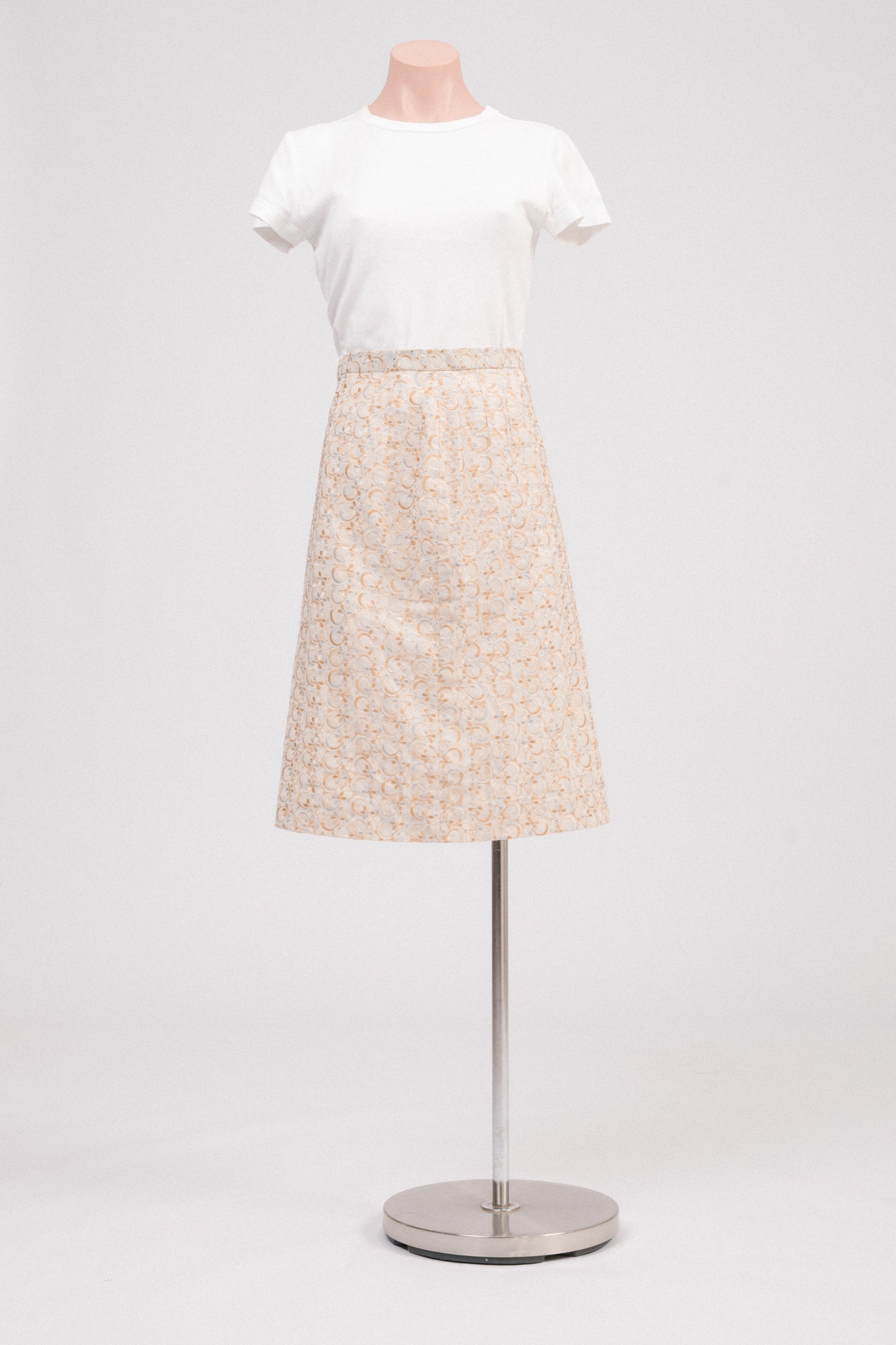 Front view of vintage beige embroidered midi skirt with floral broderie anglaise detailing and covered side zipper with adjustable hook-and-bar closure. Timeless heirloom-style vintage clothing Australia.