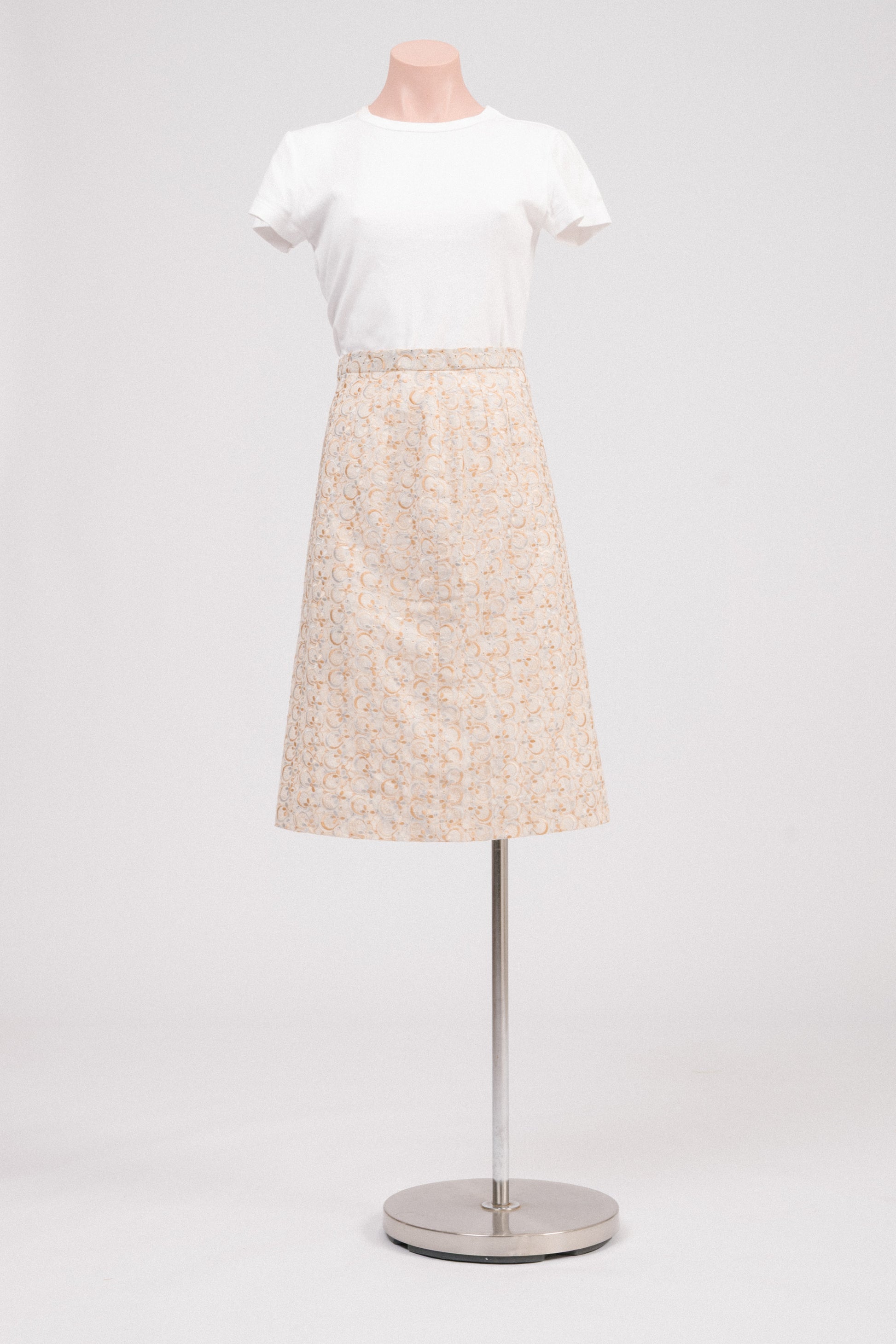 Front view of vintage beige embroidered midi skirt with floral broderie anglaise detailing and covered side zipper with adjustable hook-and-bar closure. Timeless heirloom-style vintage clothing Australia.