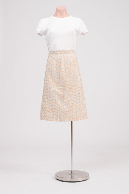Front view of vintage beige embroidered midi skirt with floral broderie anglaise detailing and covered side zipper with adjustable hook-and-bar closure. Timeless heirloom-style vintage clothing Australia.