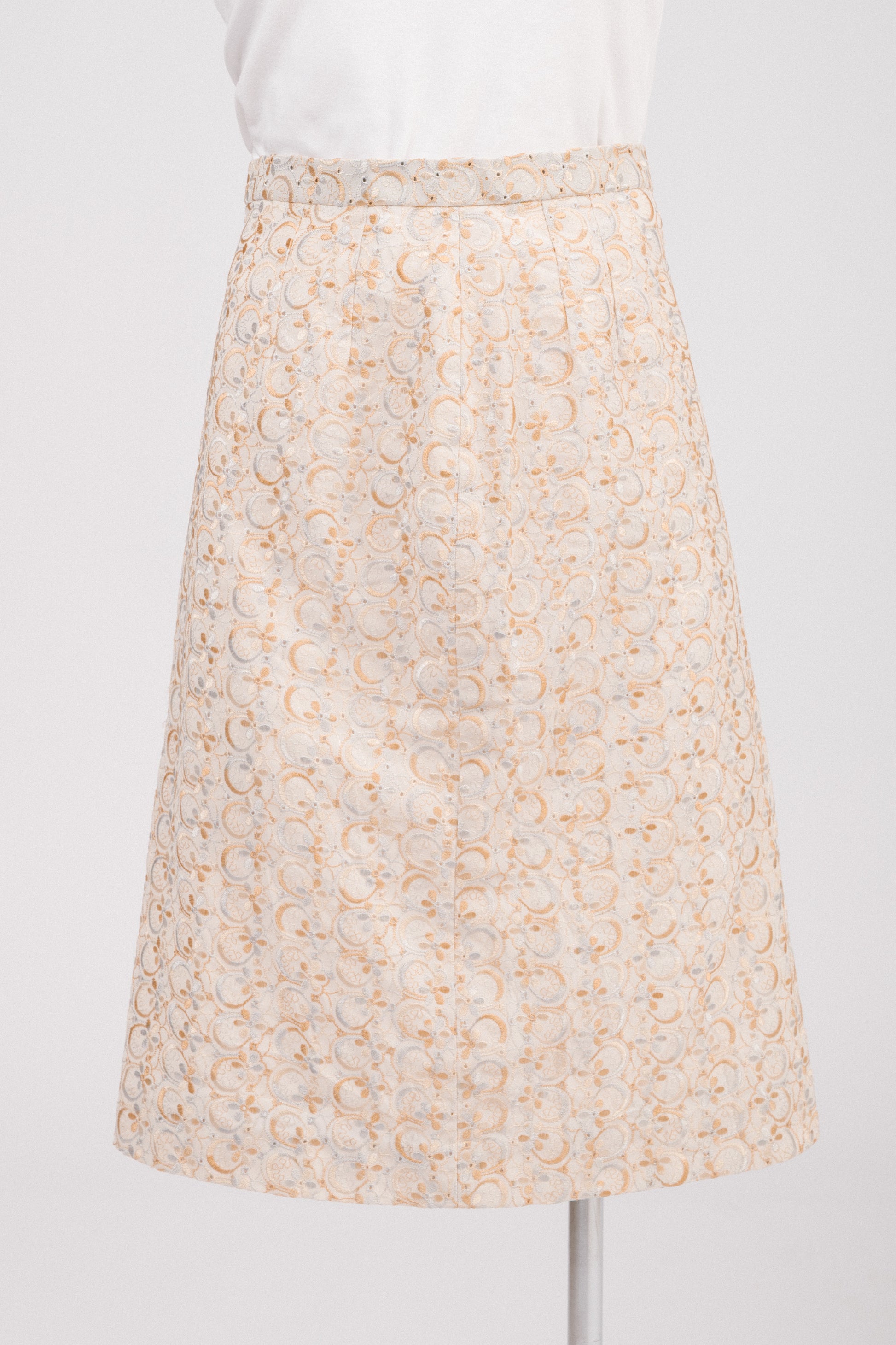 Close-up of floral embroidery and eyelet cut-out details on vintage beige midi skirt, showing textured fabric and delicate craftsmanship. Timeless feminine vintage clothing Australia.