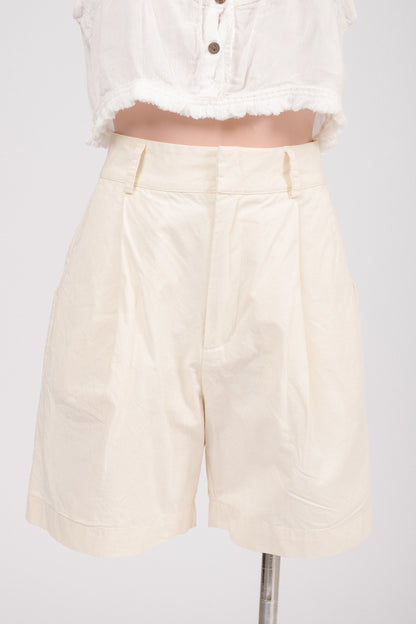 Close-up of lapped fly with hook-and-bar closure and metal zipper on buttercream shorts.