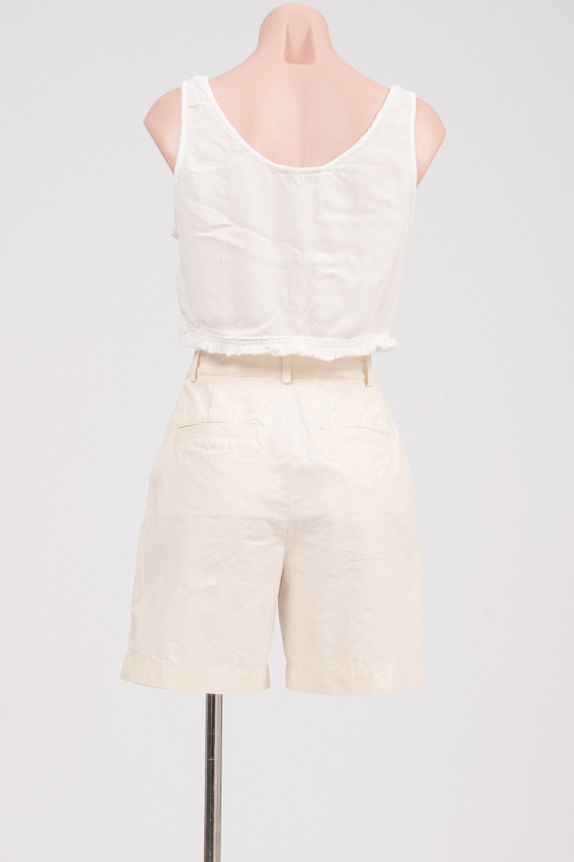 Back view showing pockets on buttercream tailored shorts.