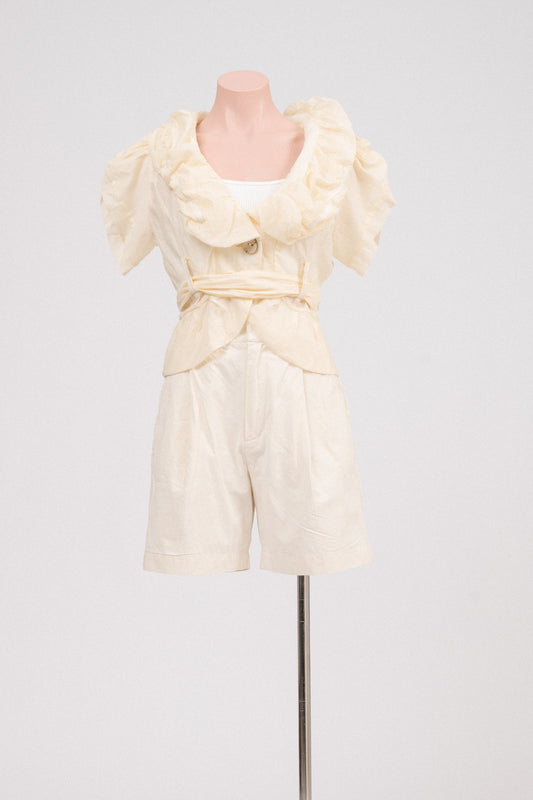 Vintage butter yellow ruffle blouse with waist tie displayed front-on.