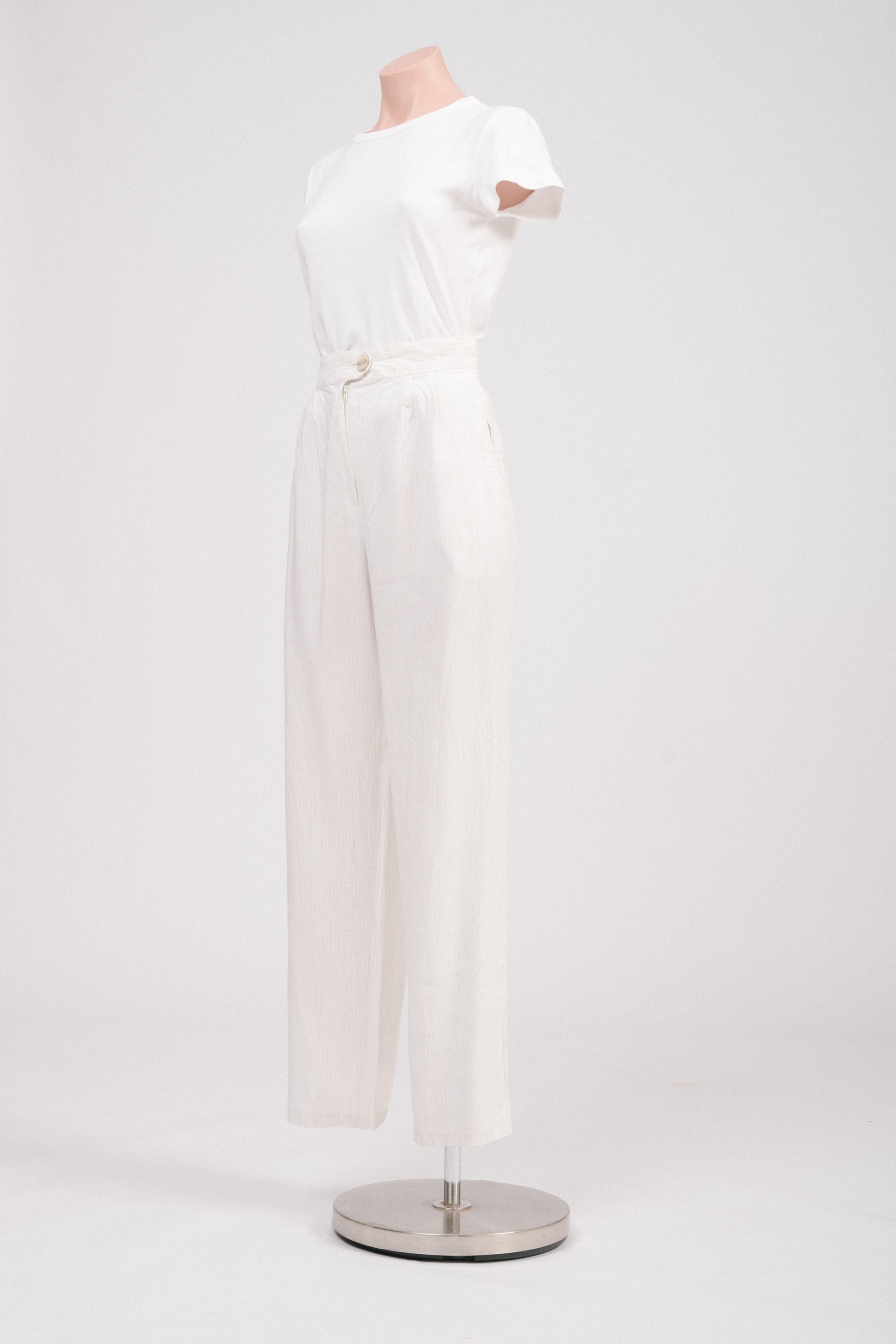Side view of striped tailored pants highlighting pocket detail.