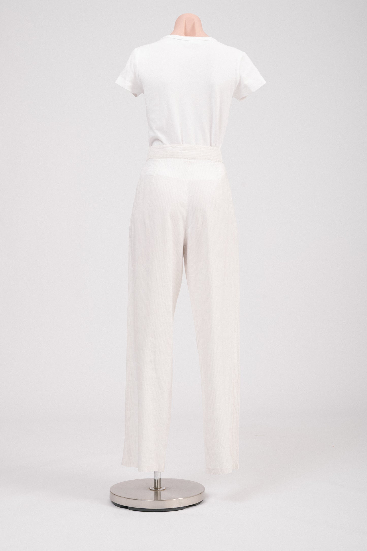 Back view of high-waisted vintage trousers showing clean tailoring.