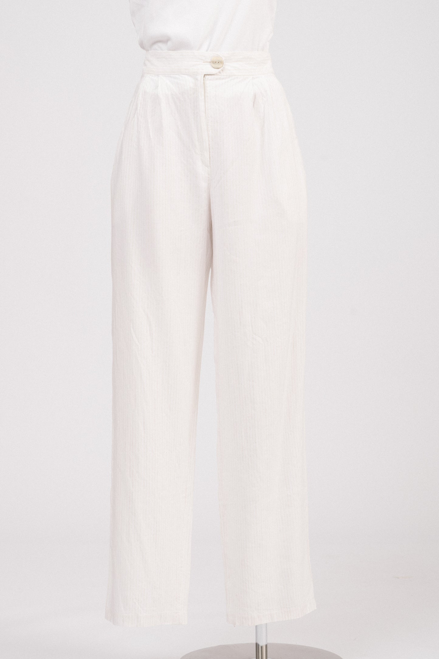 Close-up of waistband showing lapped zipper fly and textured button.