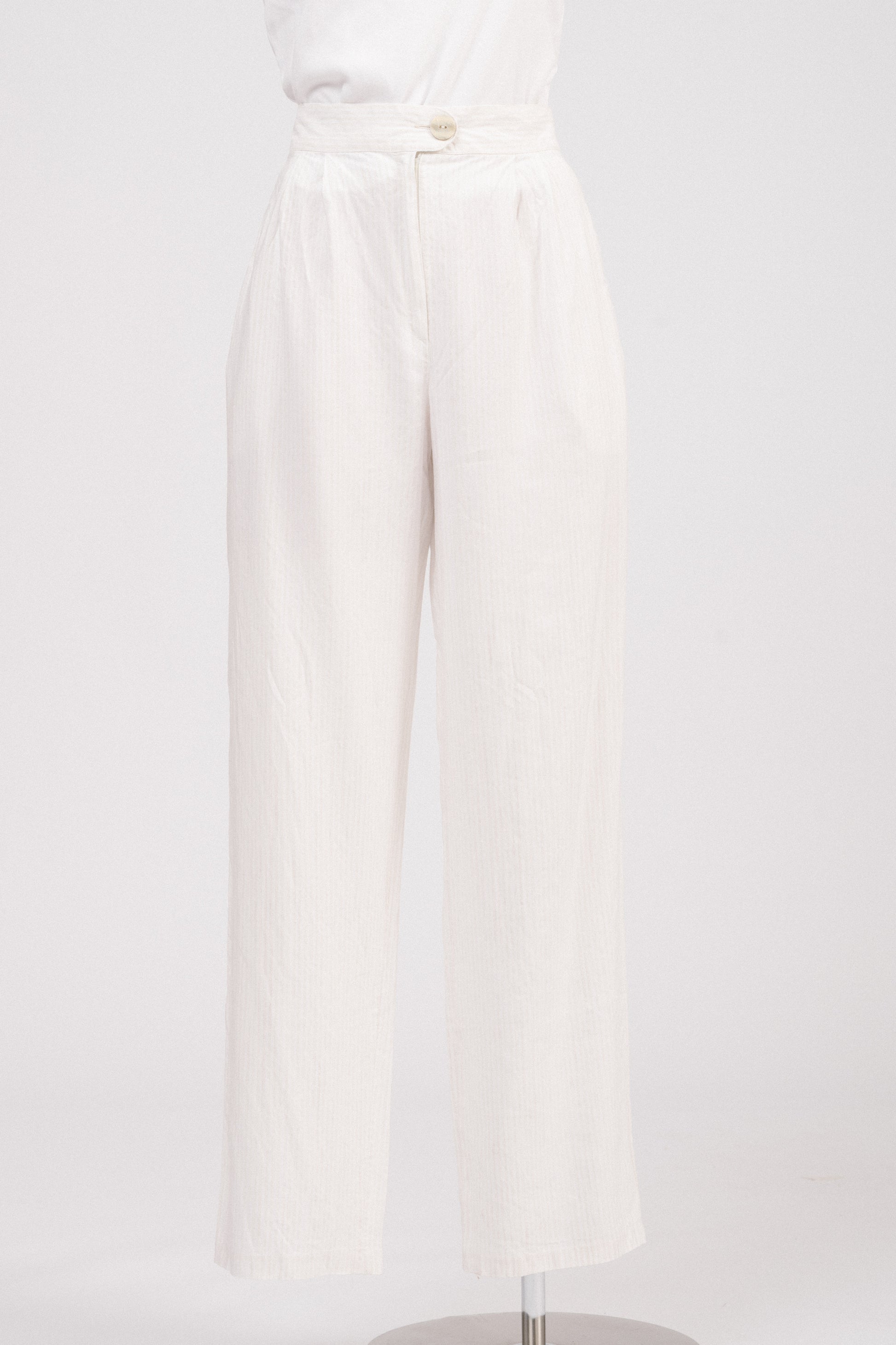 Close-up of waistband showing lapped zipper fly and textured button.