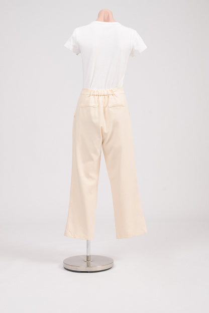 Back view of buttercream pants with elasticated waist and faux welt pockets.