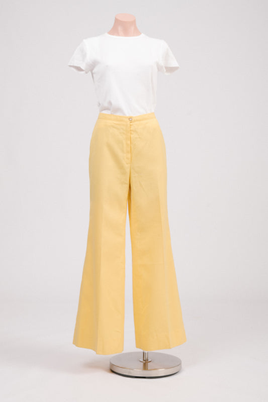 Vintage 70s sunshine yellow flare pants, front view showing tailored waistband, mid-to-high rise, full-length flared polyester mélange trousers for retro summer style.