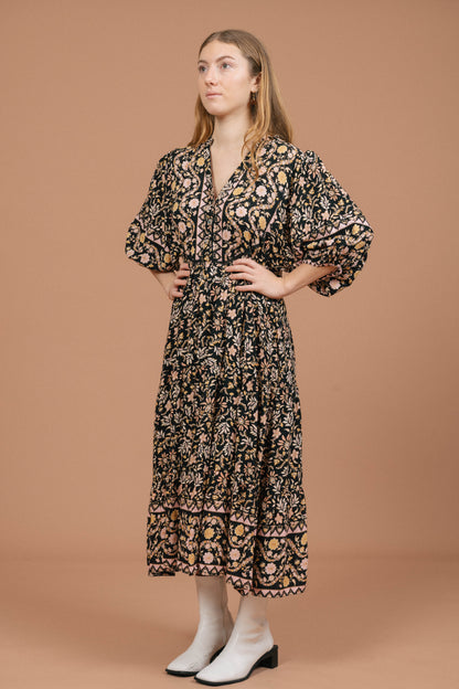 Vintage black floral midi dress with puffy sleeves and front buttons front view - Lemon Lane Vintage