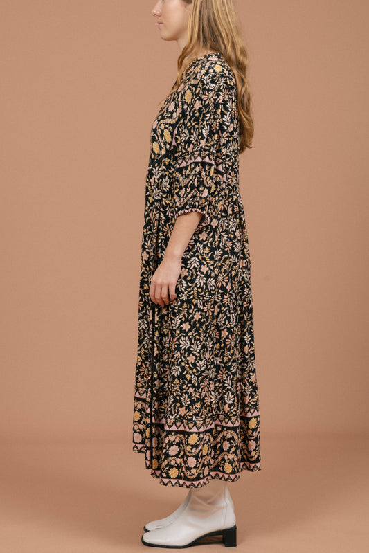 Vintage black floral midi dress with puffy sleeves and front buttons side view - Lemon Lane Vintage