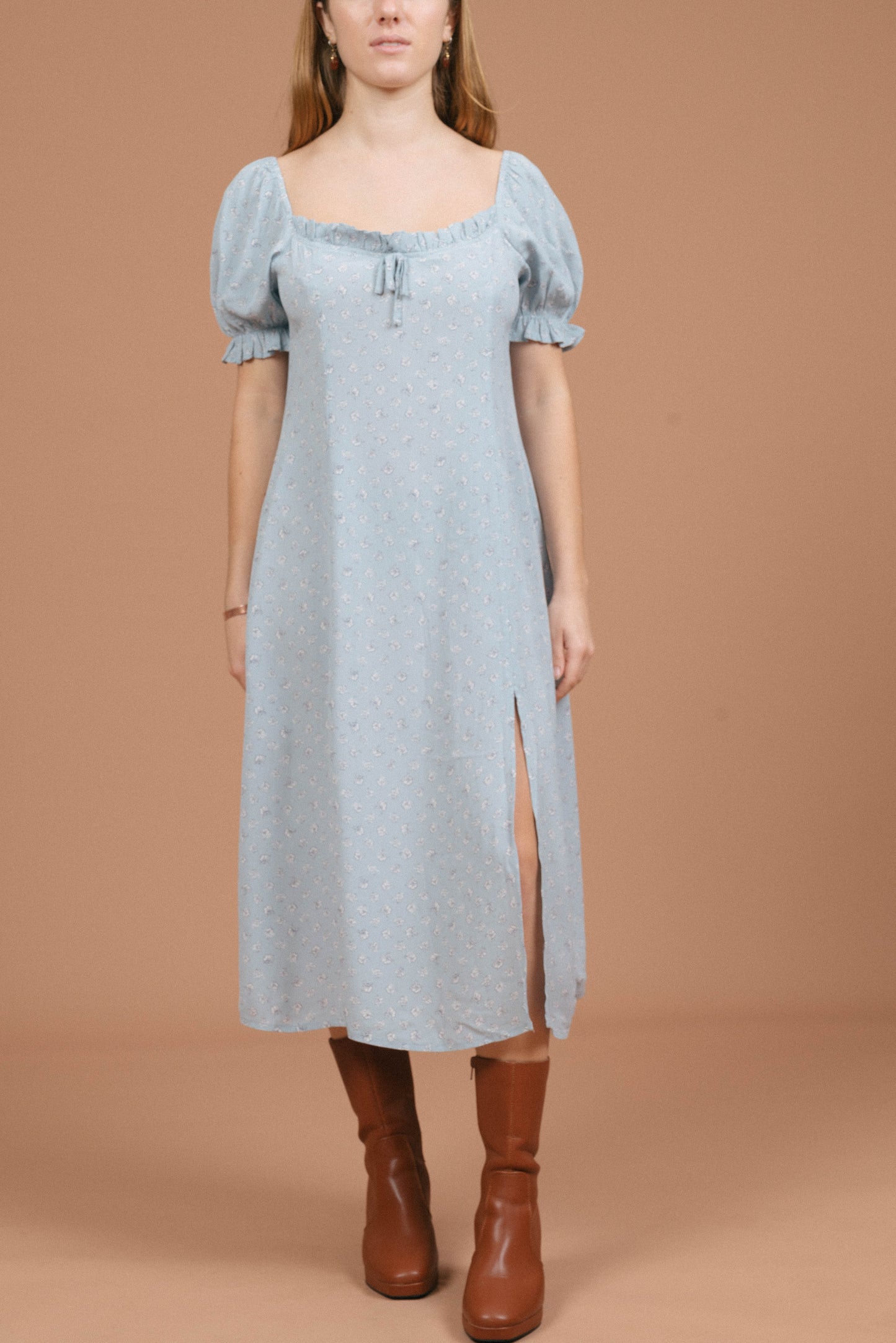 Vintage blue floral midi dress with puffy cap sleeves, ruffle detailing, and front bow front view - Lemon Lane Vintage