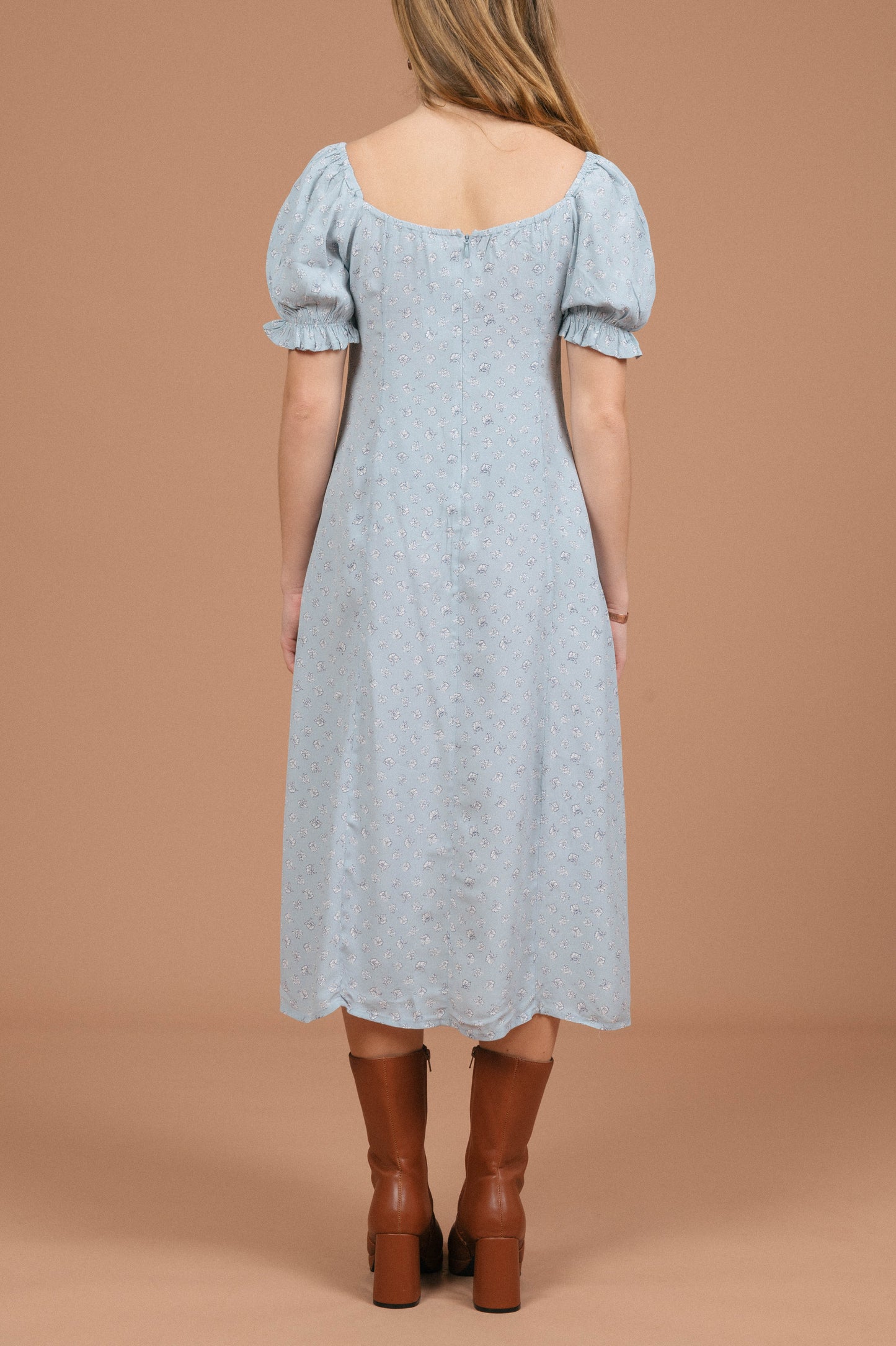 Vintage blue floral midi dress with puffy cap sleeves, ruffle detailing, and front bow back view - Lemon Lane Vintage