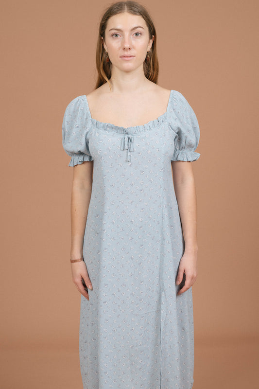 Vintage blue floral midi dress with puffy cap sleeves, ruffle detailing, and front bow front view - Lemon Lane Vintage