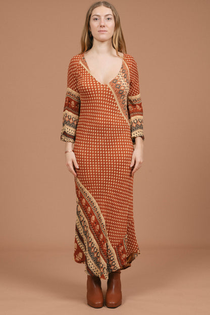 Vintage long bell sleeved slip maxi dress in rust and multi-coloured fabric front view - Lemon Lane Vintage
