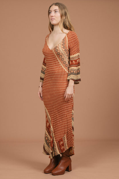Vintage long bell sleeved slip maxi dress in rust and multi-coloured fabric side view - Lemon Lane Vintage