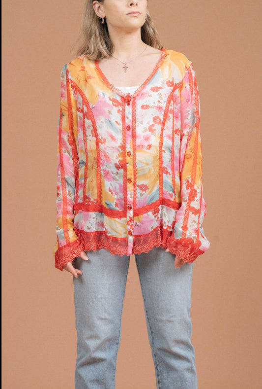 Vintage sheer floral blouse in pink and orange with lace detailing, long sleeves, and button-up front view - Lemon Lane Vintage